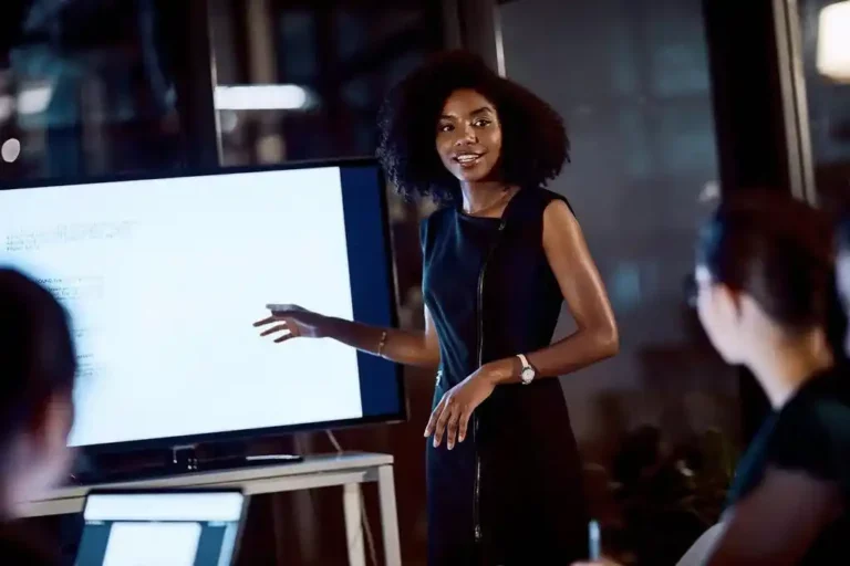 A woman inform of a television screen explaining on Anzisha Prize