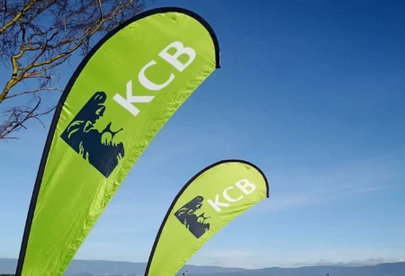 KCB Kenya teardrop banners. $100M for KCB: Empowering Women, Climate Action in Kenya.