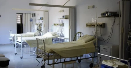 White Hospital Beds that are used by patients to recover from surgery.