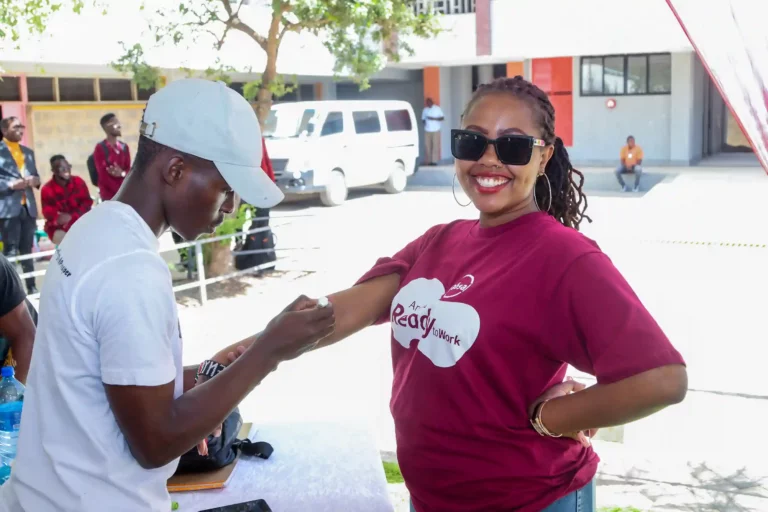 One of ABSA Kenya's Ready to work beneficiary receiving a tag. Absa Bank Kenya Fuels Growth with Youth Development Programs