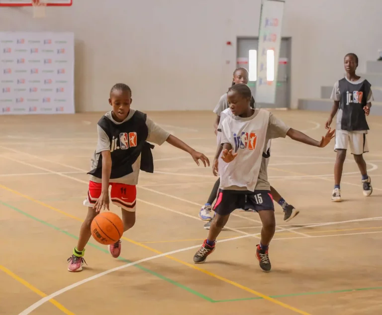 Melisa Wanjiku(L) of St. Johns’ JSS dribbles off the ball from Brenda Odoyo (R) during M-PESA Jr. NBA Nairobi regional tournament held at Sabis International School in Nairobi.