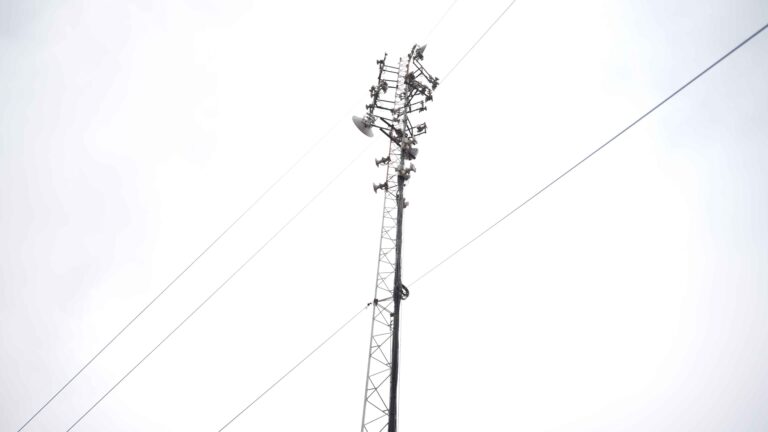 Technician installs fiber optic cable in Nairobi estate