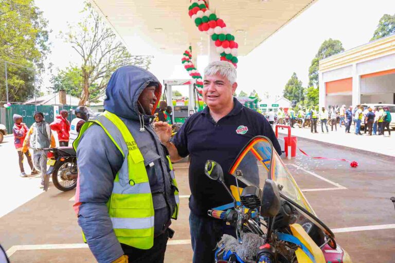 Rubis Energy East Africa CEO Olivier Sabrié (right) engages with a boda boda rider at the newly launched Rubis Champions Mall Petrol Station in Eldoret