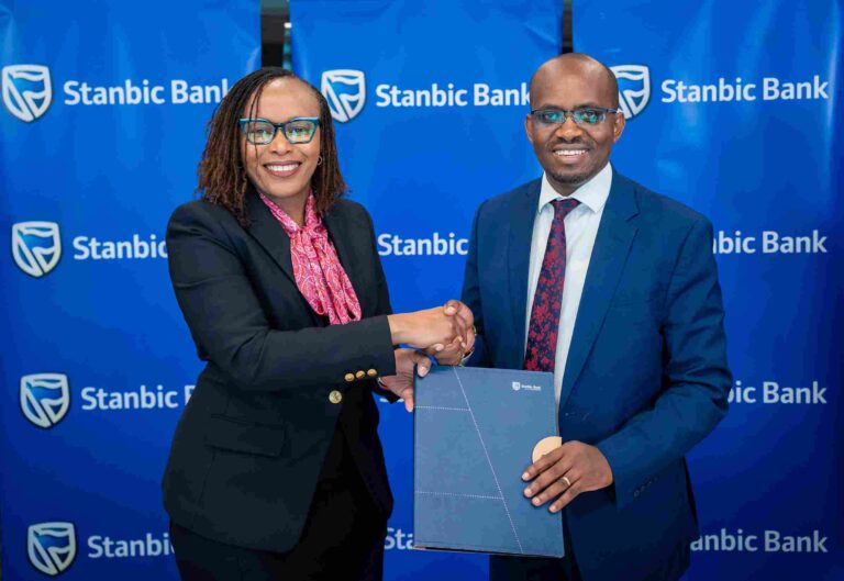 Florence Wanja (left) of Stanbic Bank and Dalmus Mbai (right) of Safer Power during MoU signing ceremony.