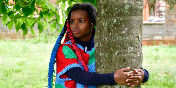 Truphena Muthoni Sets Guinness Tree‑Hugging World Record Truphena Muthoni hugging a tree during her Guinness World Record attempt in Nyeri, Kenya.