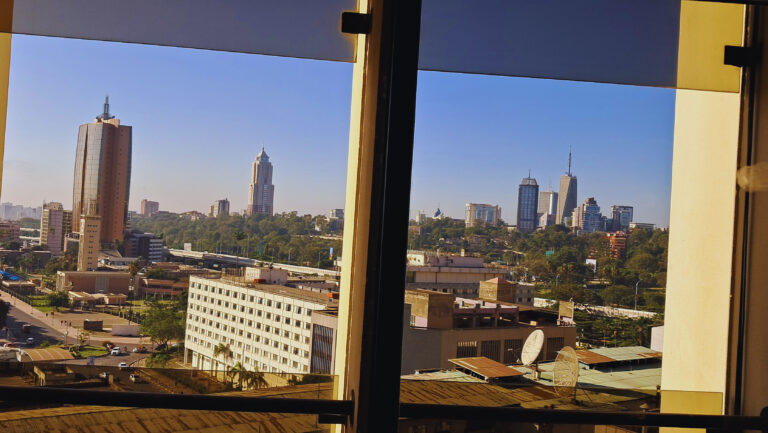 Nairobi skyline with KICC and modern skyscrapers viewed through glass windows