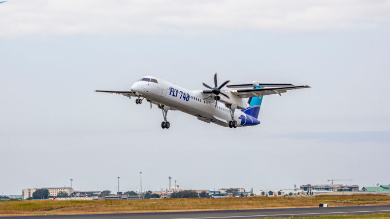 A Fly 748.com Bombardier Dash 8-Q400 aircraft on the runway at Jomo Kenyatta International Airport in Nairobi, Kenya.