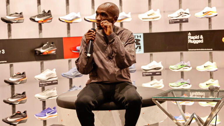 Eliud Kipchoge speaks at the opening of Nike's first flagship store in Nairobi at Sarit Centre, standing alongside local athletes and community members.
