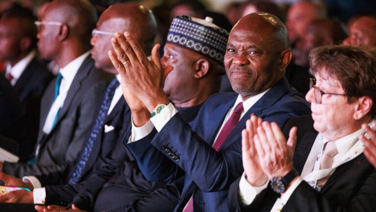Tony Elumelu, Chairman of UBA Group, applauds during a plenary session at the Africa Forward Summit in Nairobi, Kenya, May 2026, seated among delegates in a packed conference hall