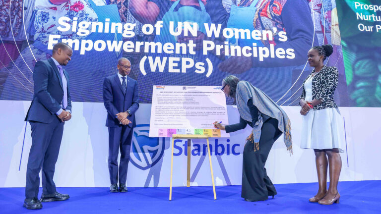 Ms. Antonia N'gabala Sodonon, UN Women Country Representative to Kenya, signs the UN Women's Empowerment Principles at Stanbic Bank Kenya's 2025 Sustainability Report launch in Nairobi, alongside Standard Bank Regional Chief Executive East Africa Dr. Joshua Oigara, the Acting Chief Executive of Stanbic Bank Kenya and South Sudan, and Global Compact Network Kenya's Mary Waweru.