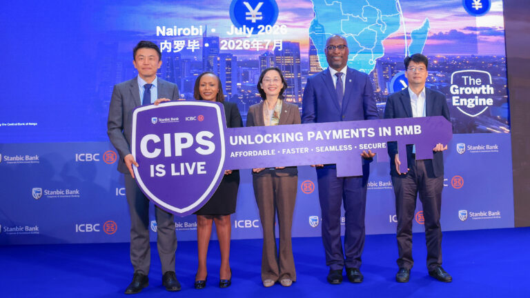 Five executives from Stanbic Bank, ICBC and the Chinese embassy hold a large sign reading "CIPS is Live" on stage at a Nairobi ceremony marking the launch of RMB payments through China's Cross-Border Interbank Payment System.