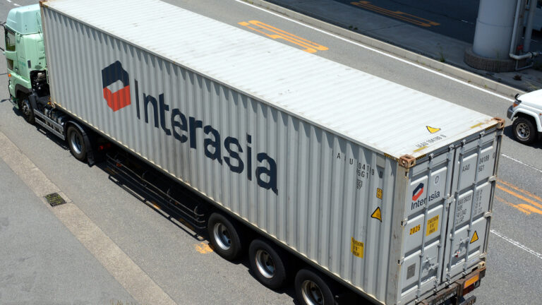 InterAsia Lines shipping container loaded on a truck trailer, viewed from above