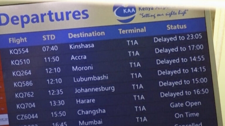 Digital flight departure board at Terminal 1A showing delayed and cancelled flights across regional and international routes.