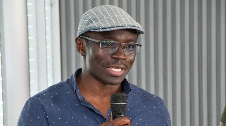 Maurice Otieno speaking into a microphone at a media event