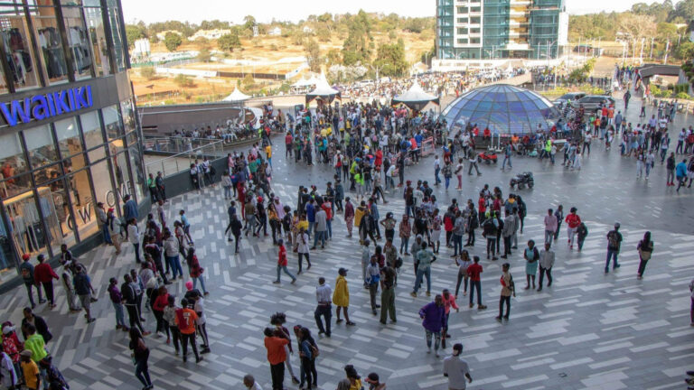 Large crowd of shoppers and visitors gathered in the outdoor plaza at Two Rivers Mall, Nairobi, w