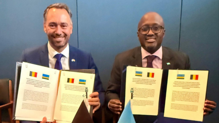 Belgian Foreign Minister Maxime Prevot and Rwandan Foreign Minister Olivier Nduhungirehe hold signed documents in New York after agreeing to restore diplomatic relations.