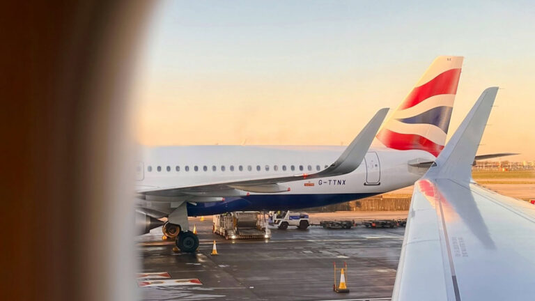 British Airways Returns To Tanzania After 13 Years British Airways aircraft tail fin and wing viewed from a cabin window on the tarmac