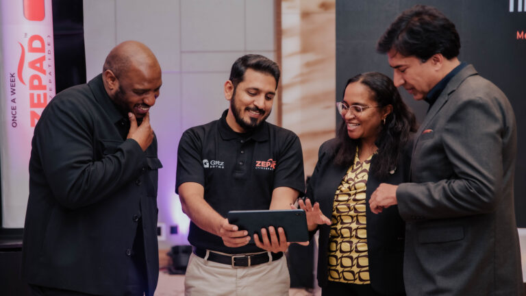 Dr Erick Njenga, Muhammad Ashad, Dr Rosslyn Ngugi, and Prof Abbas Raza view a tablet together at the Convergence metabolic disease forum in Nairobi, with a Zepad tirzepatide banner in the background.