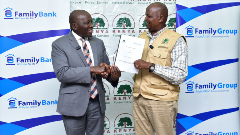 Francis Muraya of Family Group Foundation shakes hands with Alex Lemarkoko of Kenya Forest Service at the Ngong Hills signing