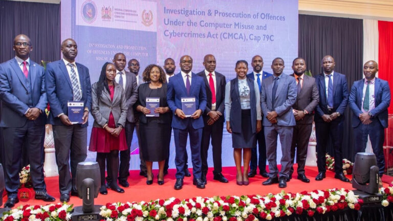 Kenyan officials pose on stage at the launch of the CMCA reference guide