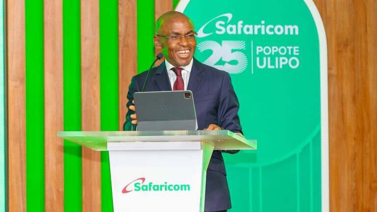 Safaricom Group CEO Peter Ndegwa speaks from a lectern with a tablet at the launch of the 2026 Sustainable Business Report in Nairobi